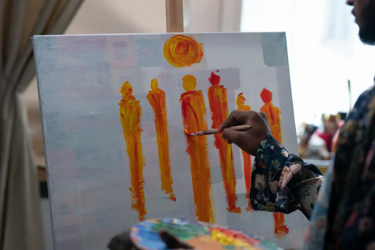 Painting on a canvas at an easel