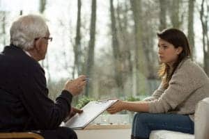 Psychiatrist talking to his patient during a dual diagnosis treatment therapy