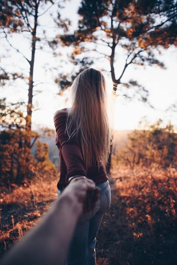  couple holding hands nature walk