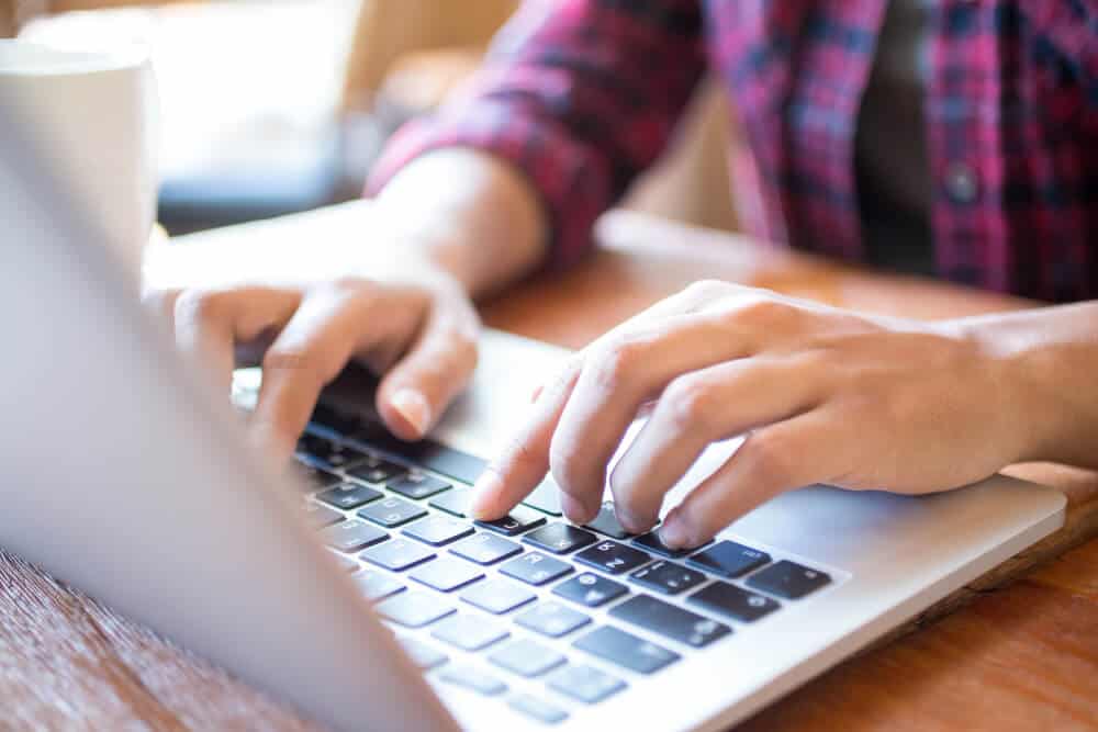  close up typing laptop table