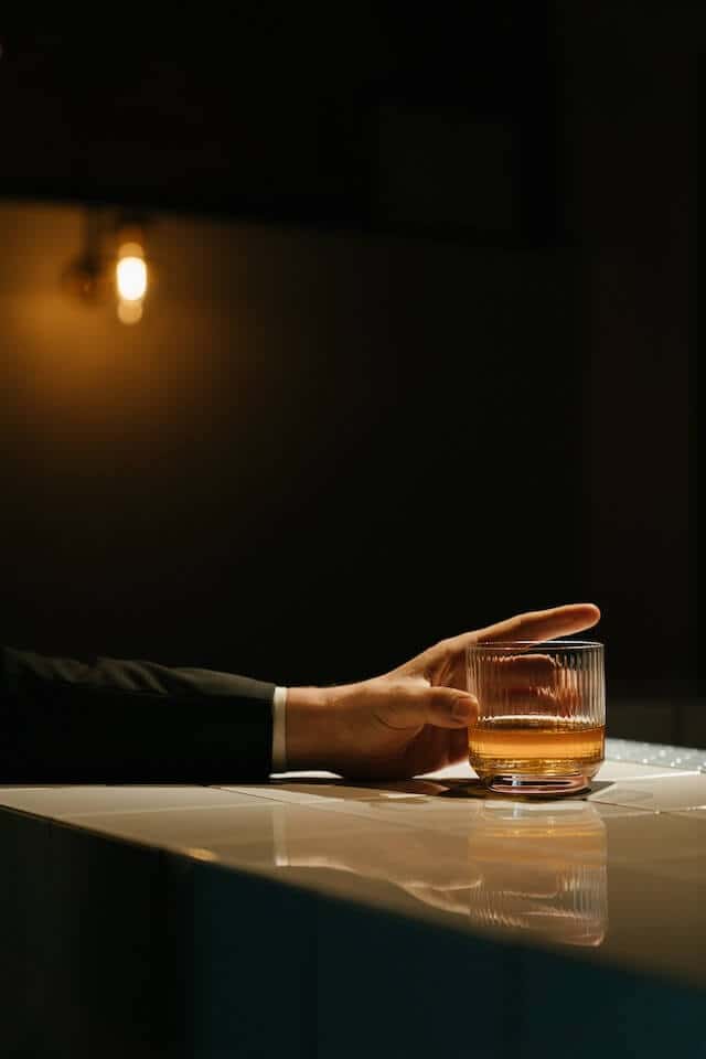 man-holding-alcohol-glass