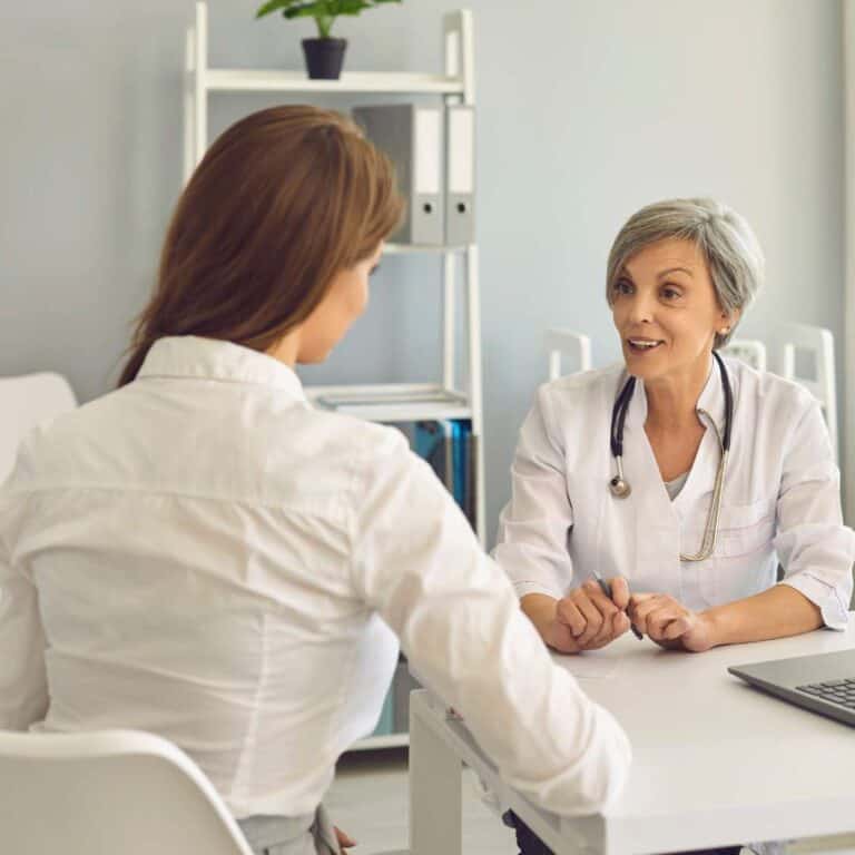  Cognitive Behavioral Therapy Program Senior Woman Doctor Therapist Consulting Young Woman Patient in Medical Clinic Office