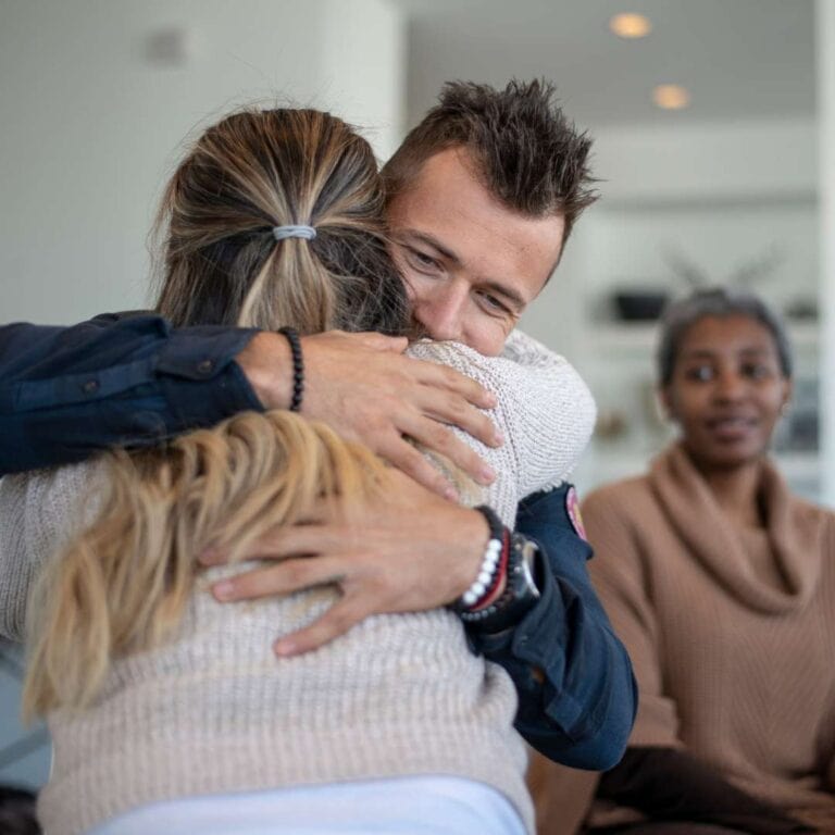  Psychoeducation Group Therapy Services Two People Hugging During Group Therapy