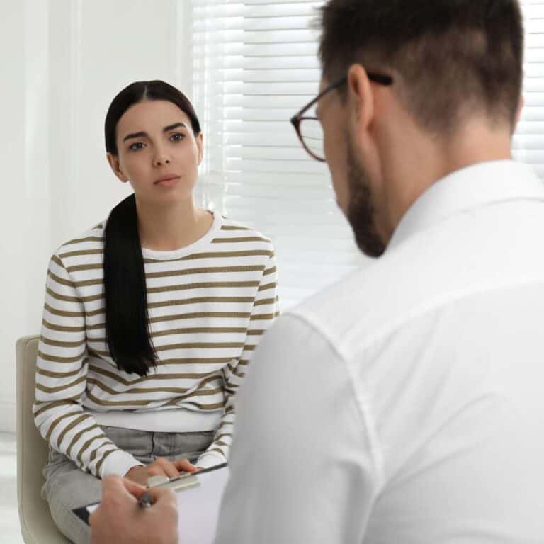  Psychotherapist Working with Drug Addicted Young Woman Indoors