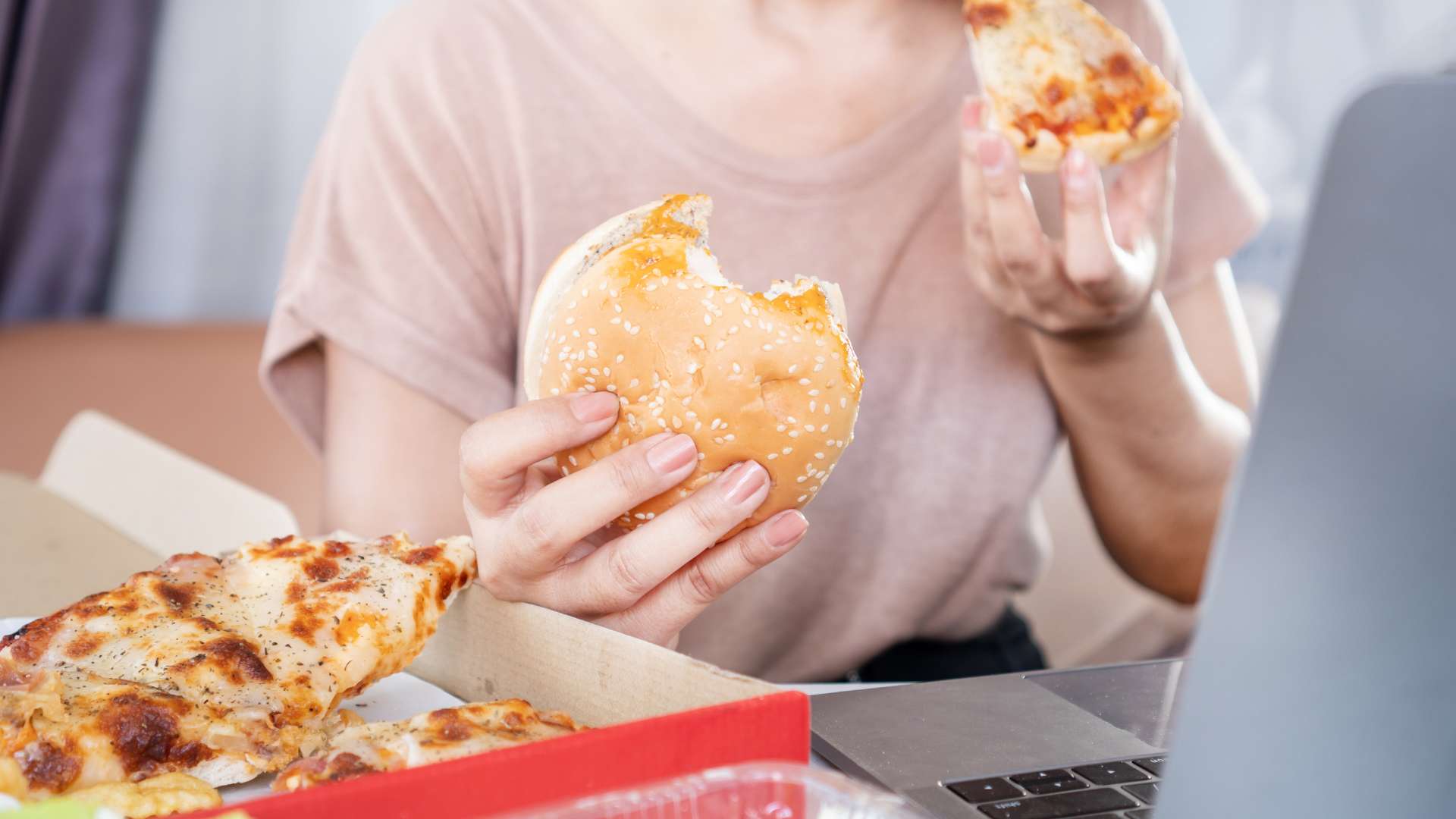  Binge Eating Disorder Treatment Woman Eating Junk Food in Front of Computer
