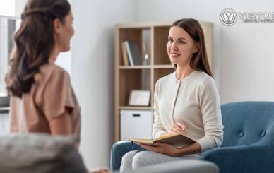 Virtue Recovery Center: Drug & Alcohol Rehab & Treatment A therapist sits explains cognitive behavrioal therapy sobriety after cocaine addiction